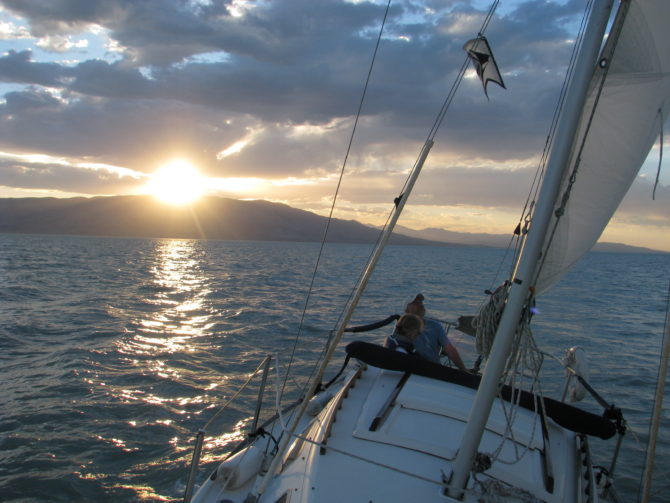 sailboat on a lake at sunset