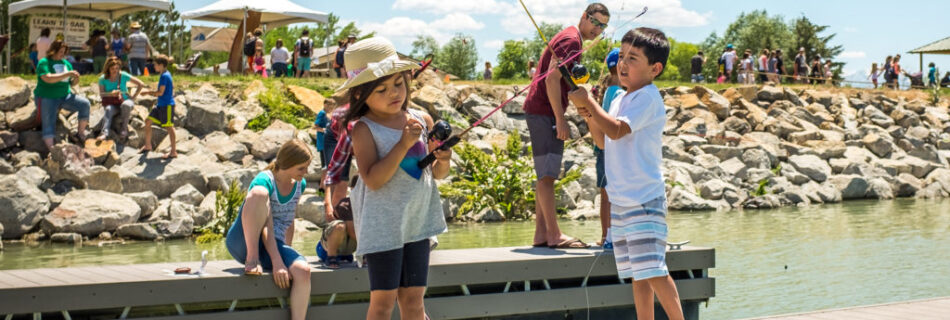 children fishing on a dock at the lake